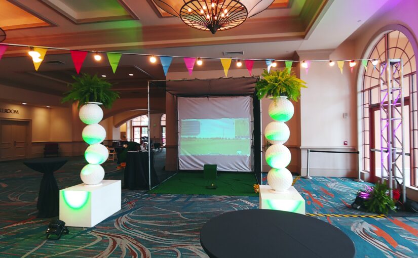 Golf Simulator Rental inside a hotel complete with giant golf ball statues, artificial grass and more.